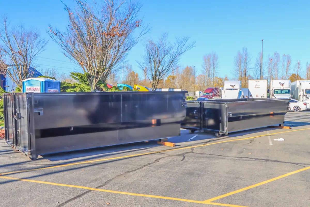 Professional dumpster rental service with roll-off container on residential driveway in Walnut Ridge